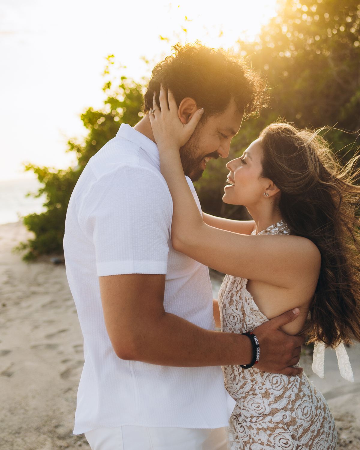 Couple embracing on the beach in golden light