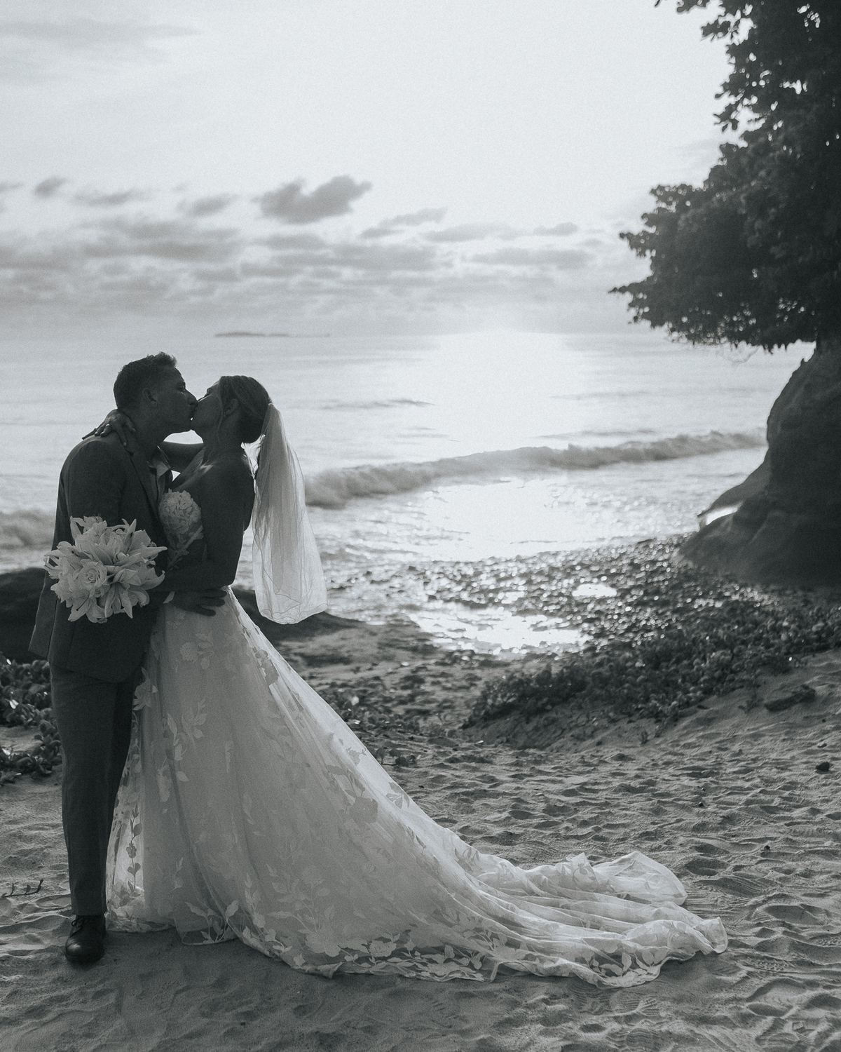 Bride and groom kissing on the sand