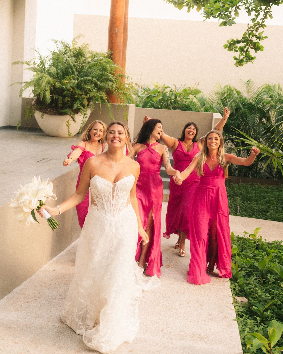 Bride walking with her bridesmaids