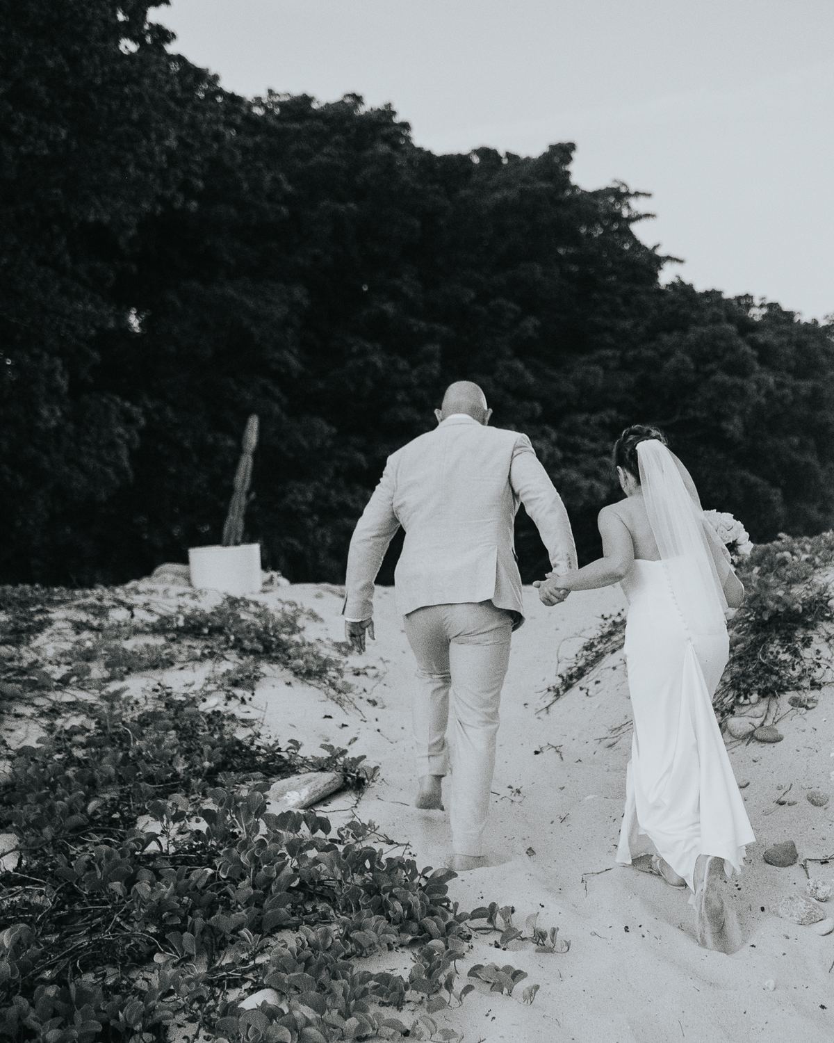 Couple walking up a dune